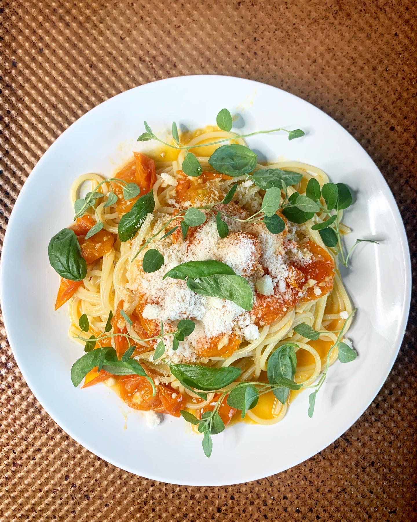 Spaghetti with Burst Cherry Tomato Sauce and sprigs of Fresh herbs