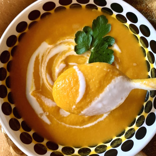 Bowl of carrot ginger soup with a coconut milk swirl