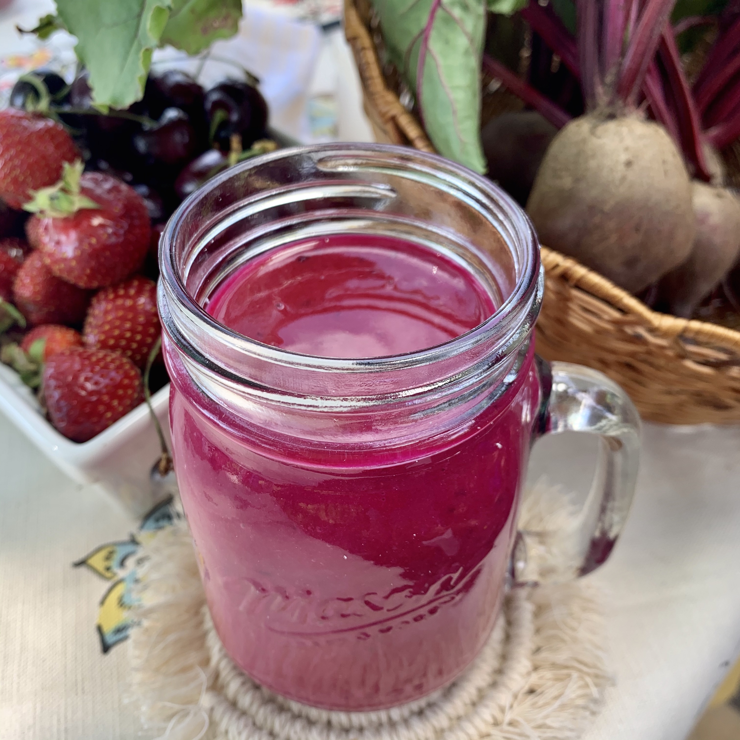 Pink cherry berry smoothie in a mason jar glass