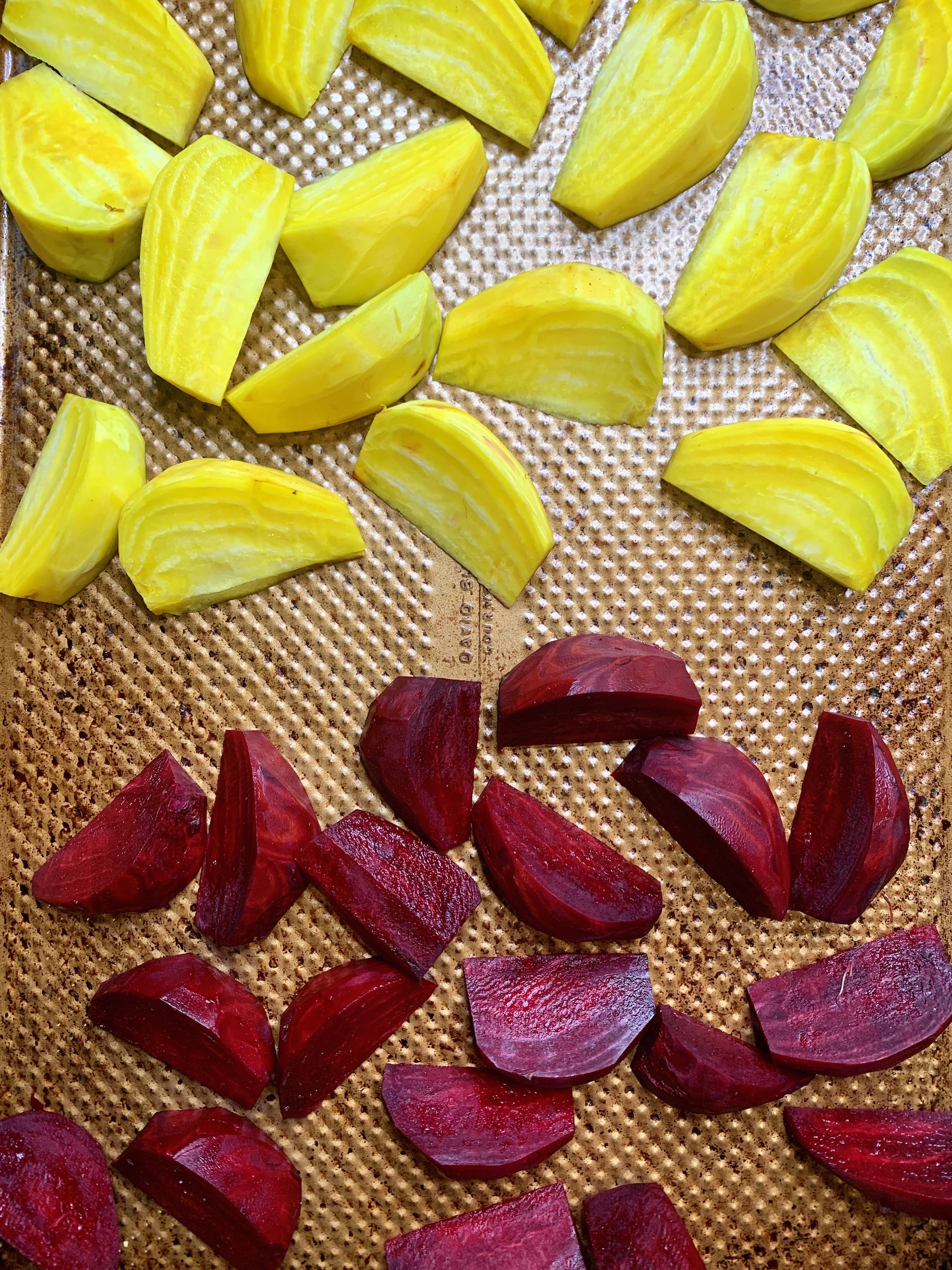 red and golden beets on a baking sheet