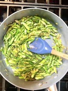 Sauteed leeks and asparagus in a pan