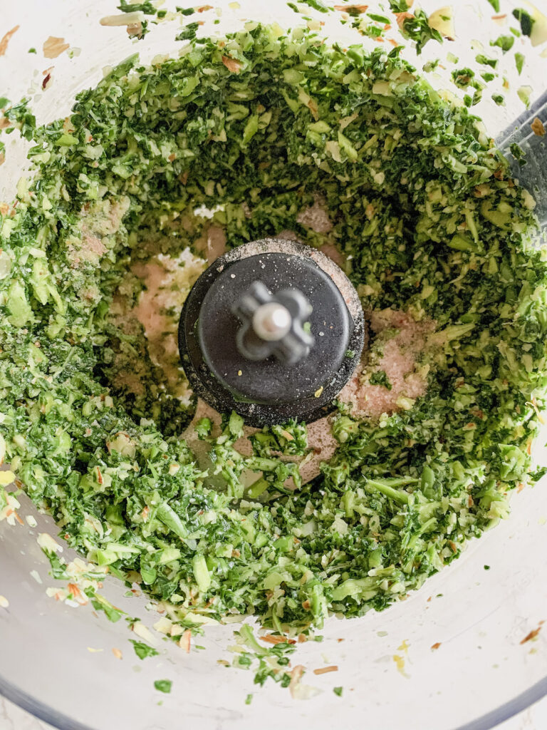 Greens, nuts, lemon juice and zest pulsed together in the bowl of a food processor