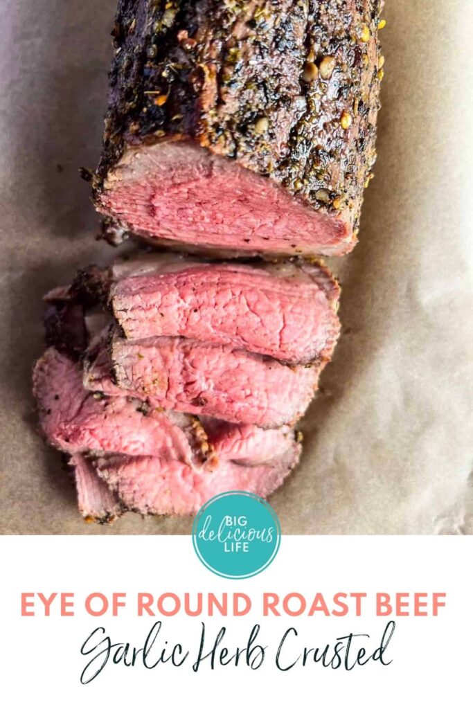Pinterest image of Garlic herb crusted eye of round roast beef with logo and text.