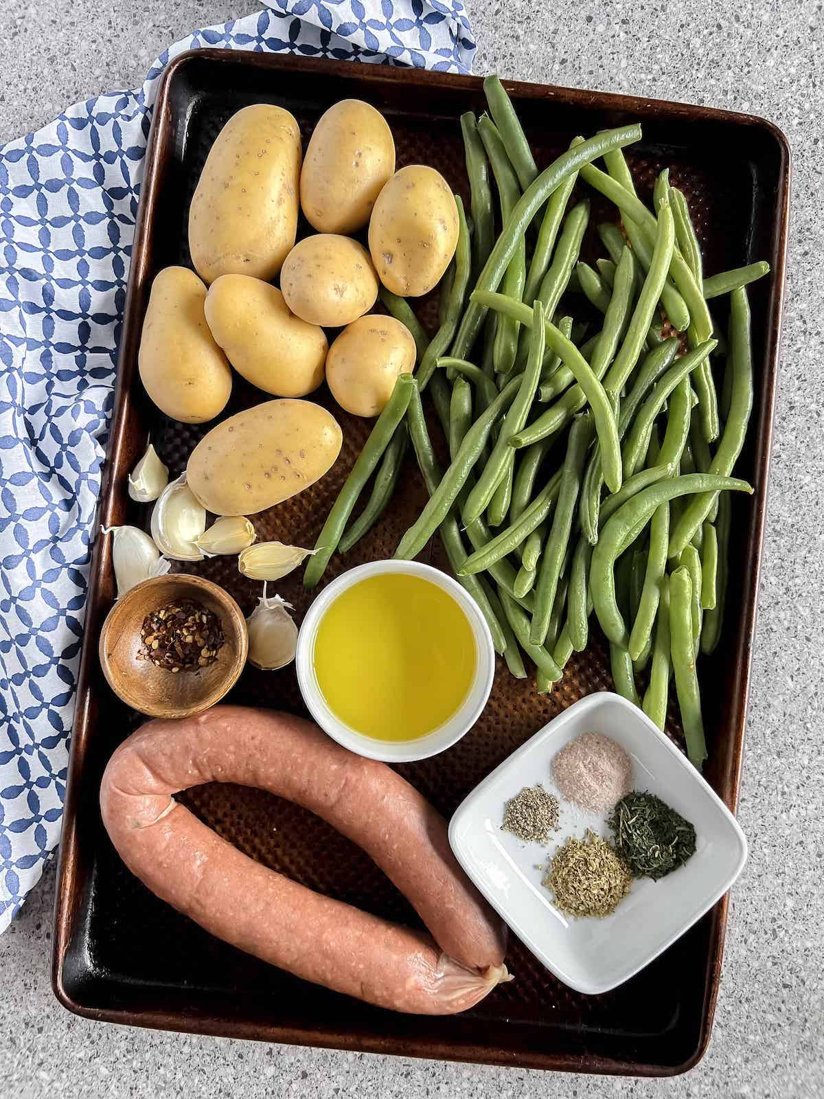 Ingredients on a sheet pan with a blue patterned napkin.