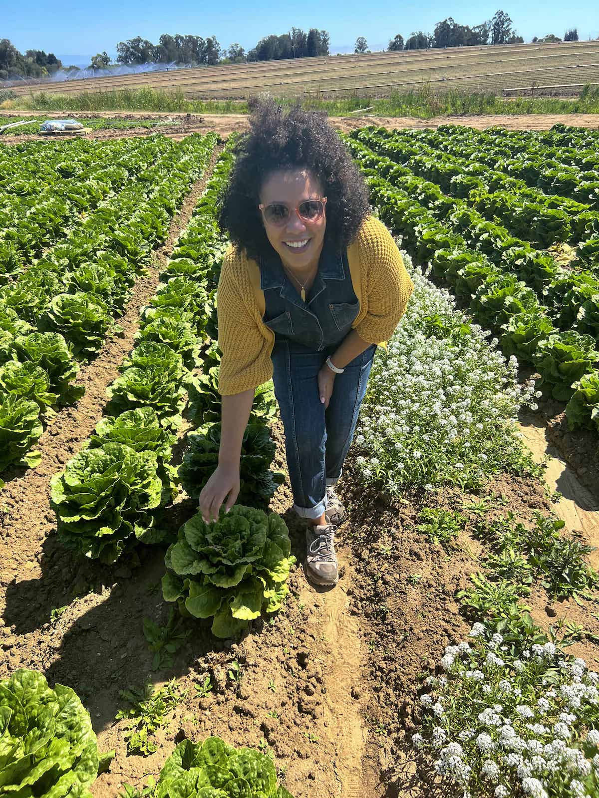 Jessica from Big Delicious Life standing in the lettuce field at Lakeside Organic Gardens in Monterey, California.