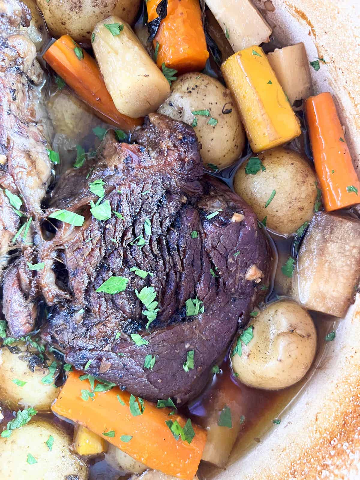 Close up of pot roast in a dutch oven.