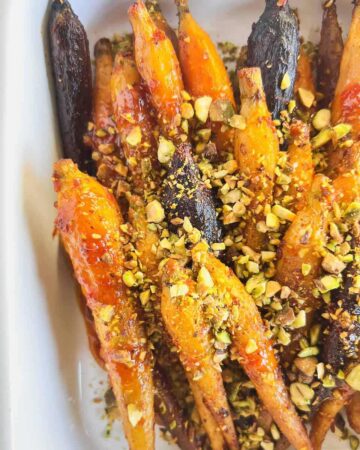 Roasted glazed carrots topped with chopped pistachios.