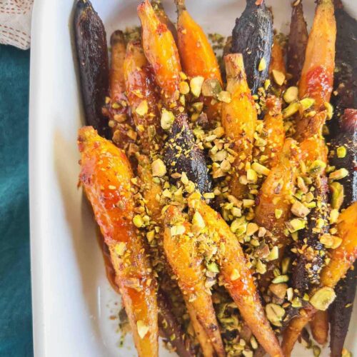 Roasted glazed carrots topped with chopped pistachios.