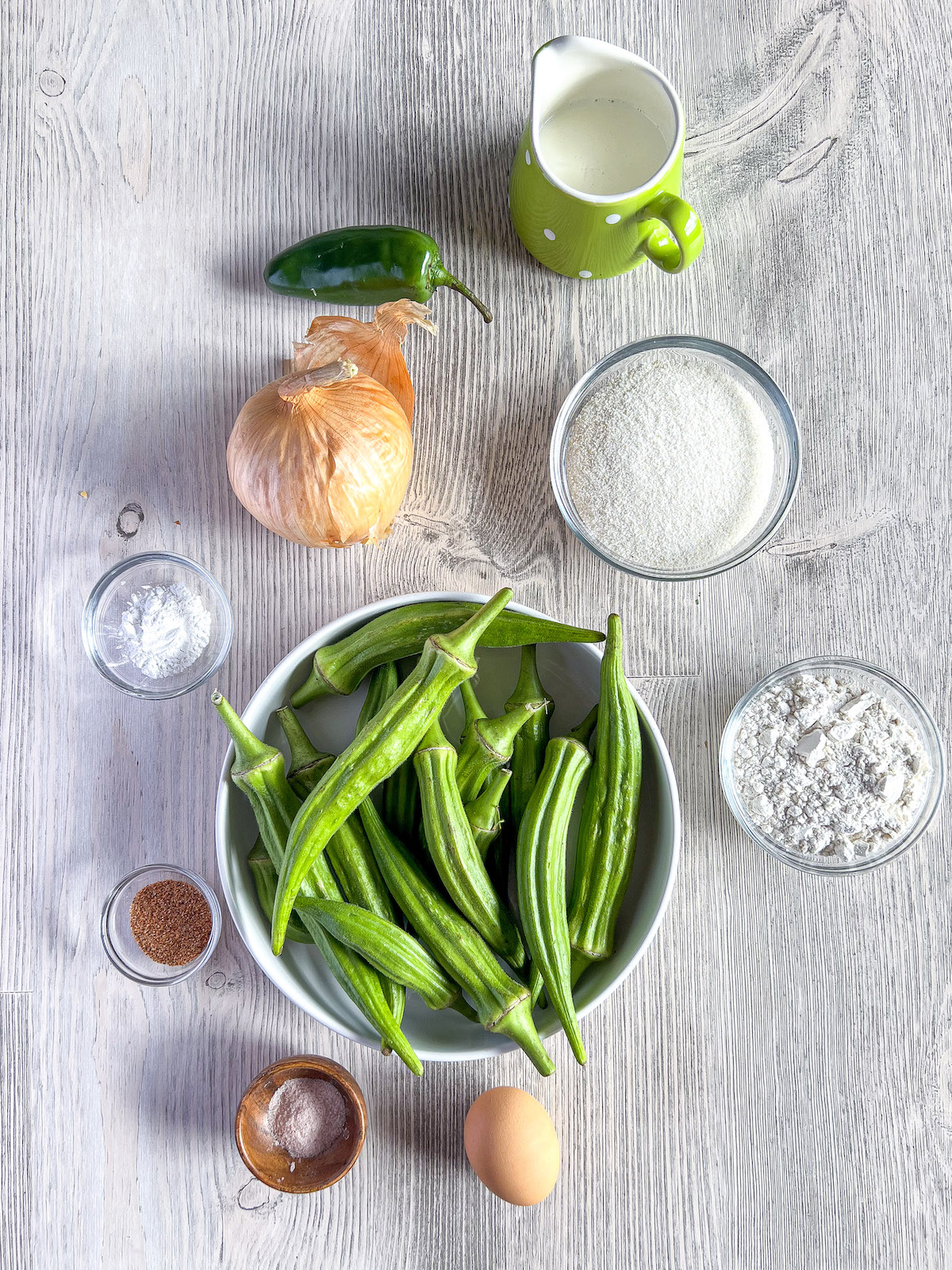 Ingredients for okra fritters in small bowls.