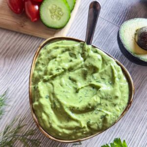 A bowl of avocado ranch dressing on the table ready to serve.