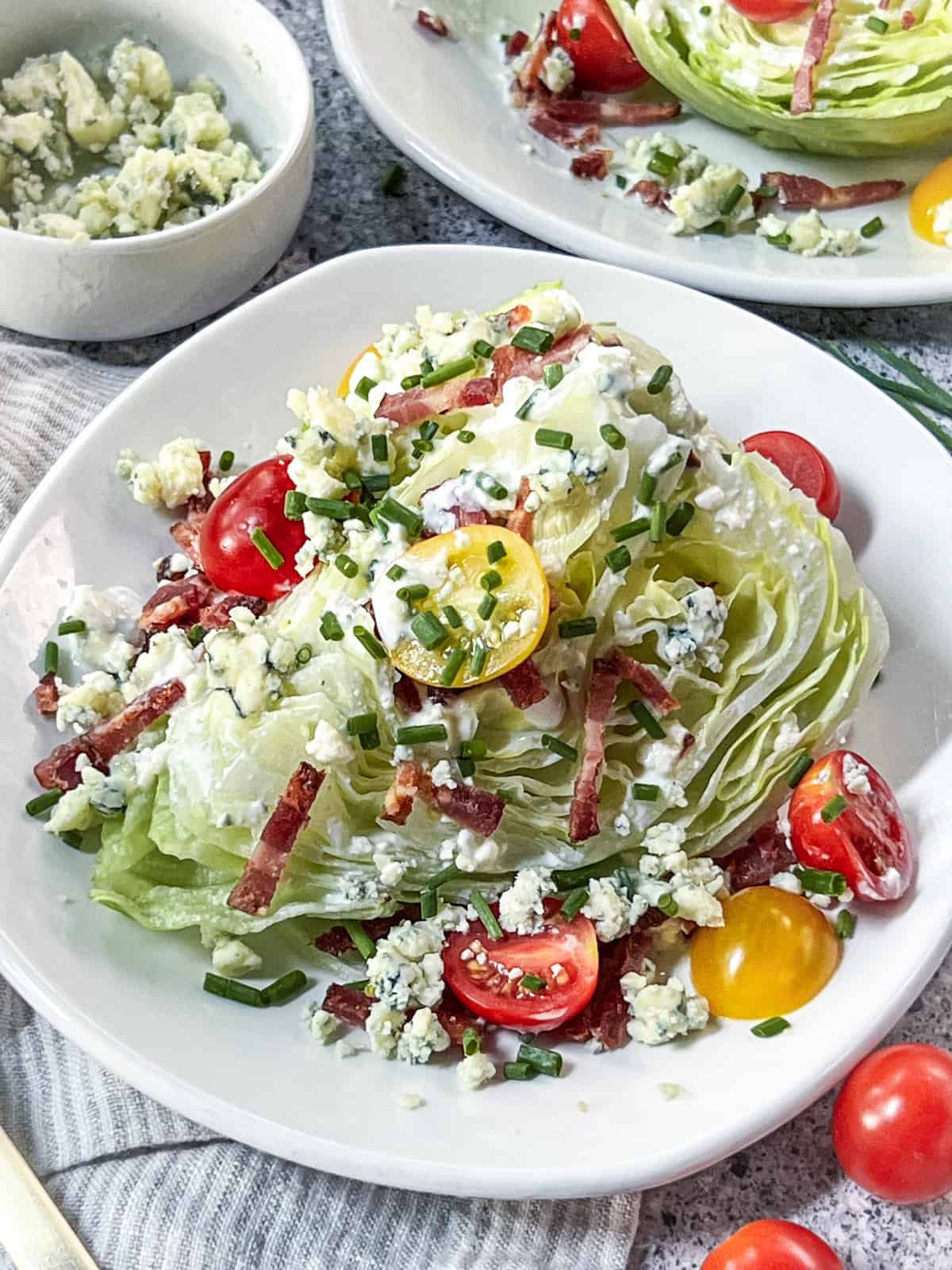 Close up of classic wedge salad on a white plate.