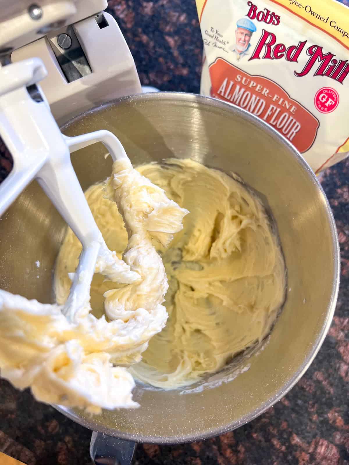 Creamed butter, sugar and extracts in the bowl of a stand mixer with the paddle attachment.