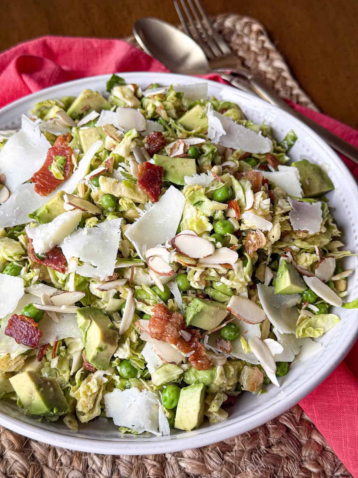 Raw shredded Brussels Sprouts Salad in a white bowl.