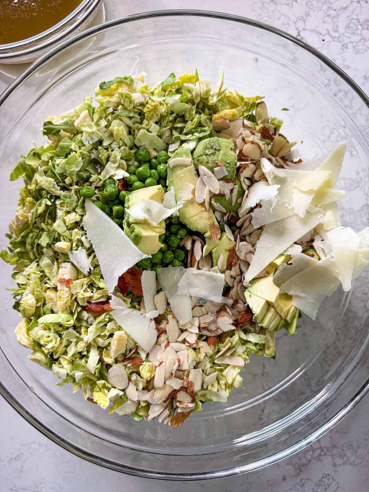 All salad ingredients in a glass bowl.