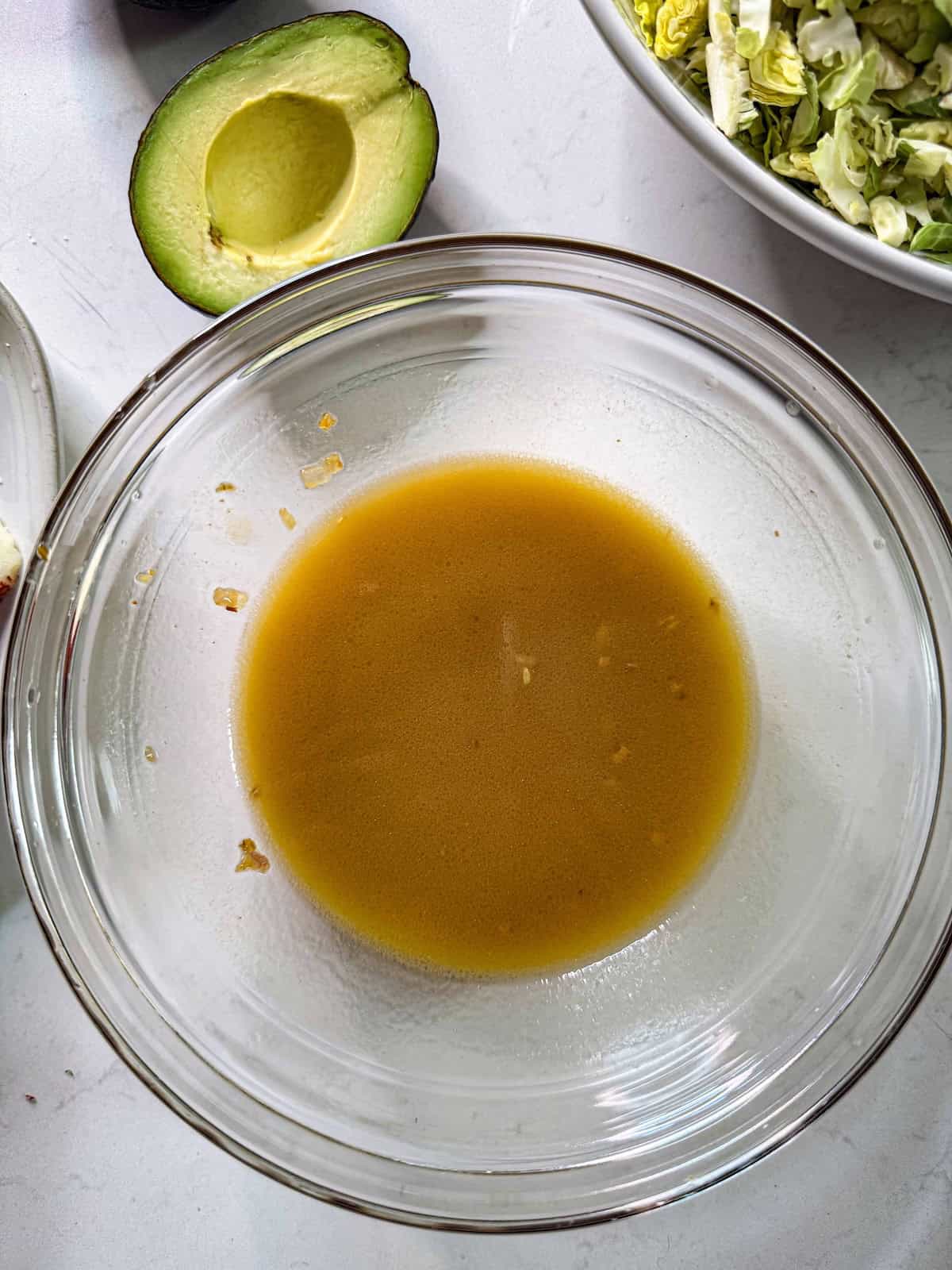 Mustard vinaigrette dressing mixed in a glass bowl.