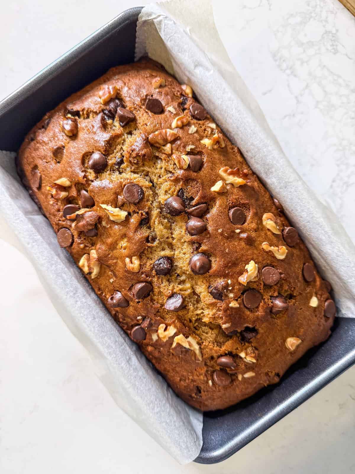 Baked banana bread in a loaf pan.
