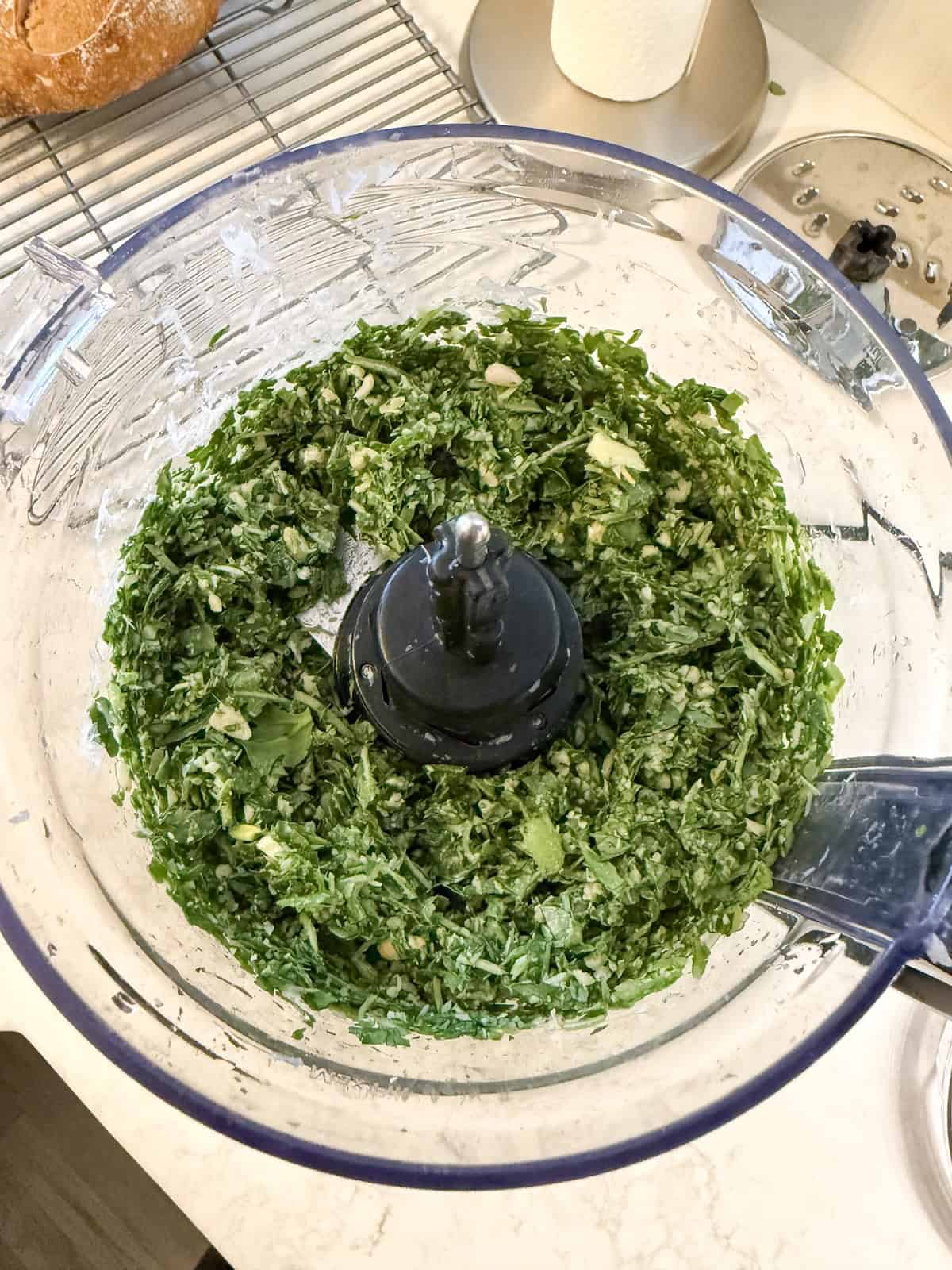 Arugula, garlic, lemon, parmesan cheese and salt pulsed in a food processor.