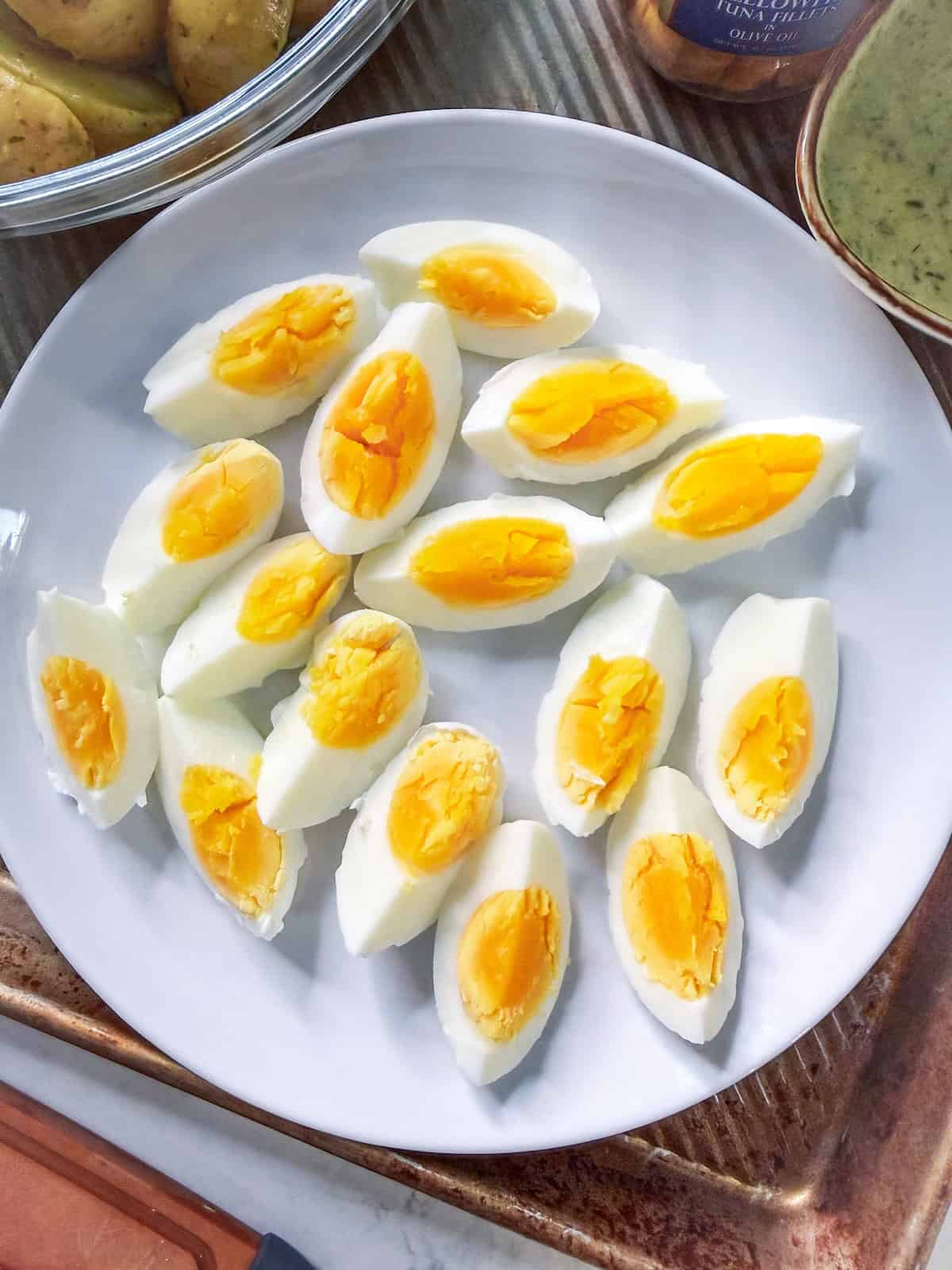 Sliced boiled eggs on a white plate.