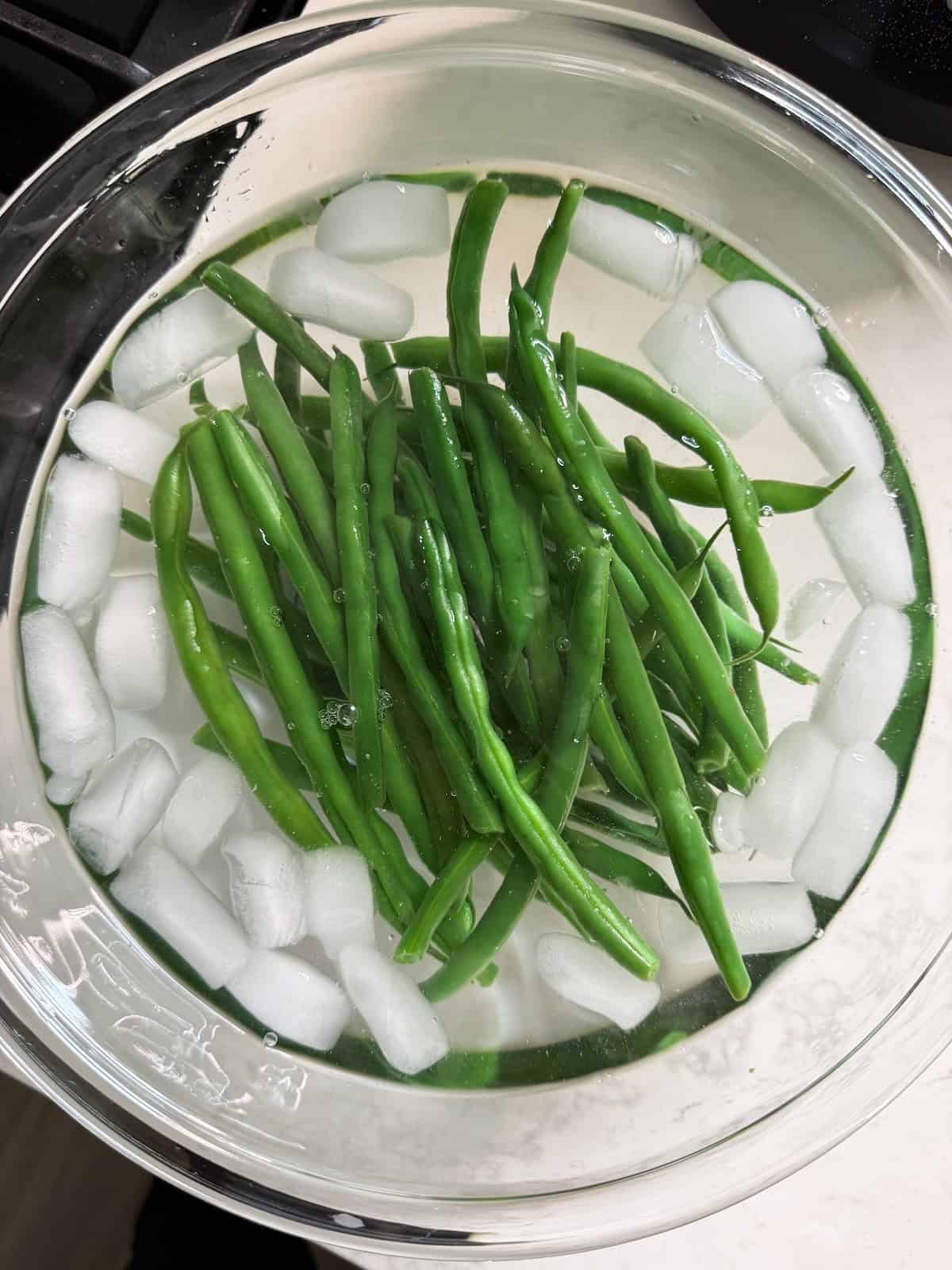 Blanched haricot vert in an ice bath.
